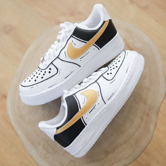 Air Force 1 custom "Cartoon Gold" avec contours dessinés à la main et swoosh doré, sneakers Nike personnalisées façon cartoon